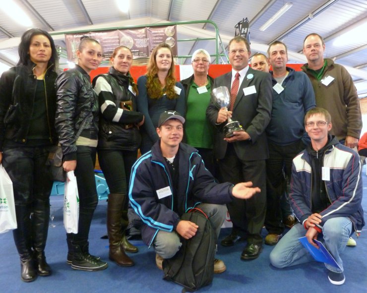 Robert Mitchell holds The R.Mitchell Challenge Cup surrounded by his loyal team.