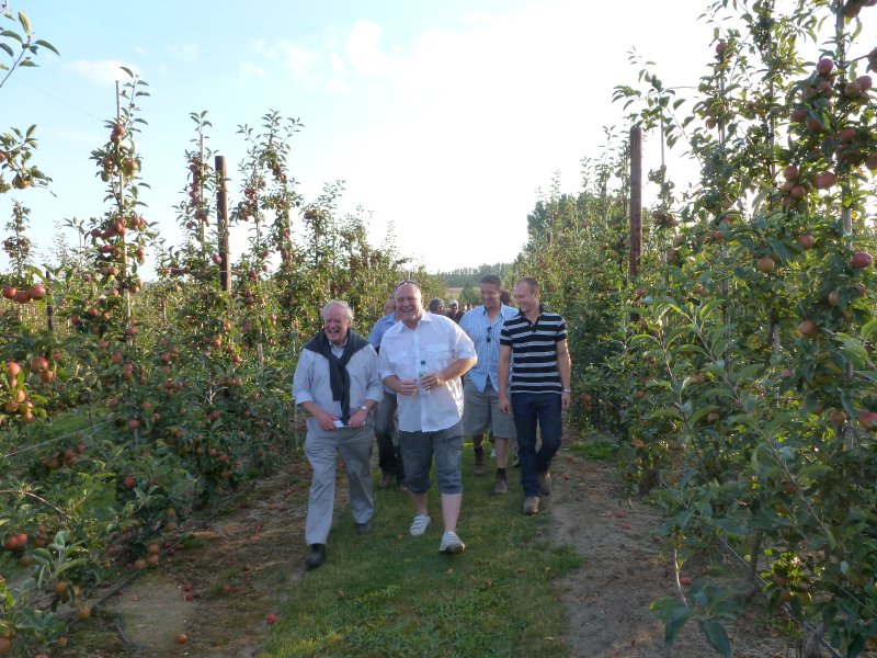 Harry Wooldridge (front left) and Nigel Stewart (white shirt) lead members through Gala orchards at Gore Farm