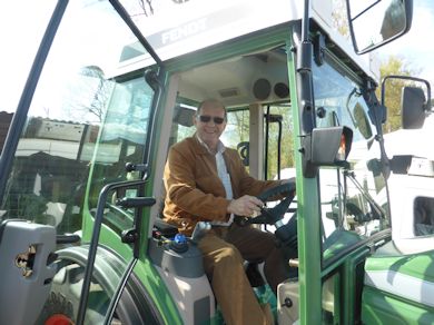 The English Apple Man poses in a FENDT - All boys love a new tractor - even those in their seventies