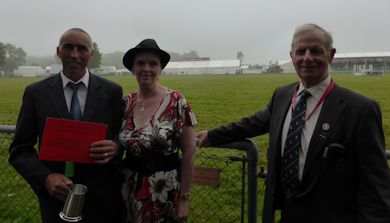 John Caddick poses with his award with his wife and Ralph Stevens